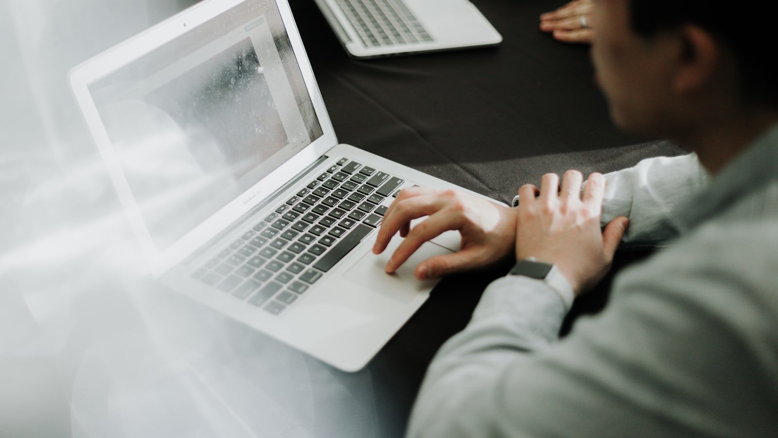 a man sitting in front of a laptop computer